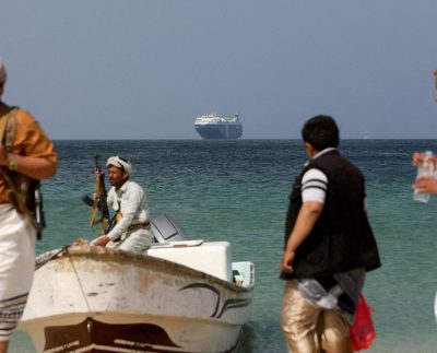 File Photo: Armed Men Stand On The Beach As The Galaxy Leader Commercial Ship, Seized By Yemen's Houthis Last Month, Is Anchored Off The Coast Of Al Salif