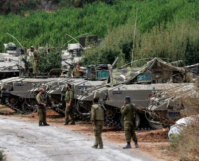 Israeli Soldiers Gather Near Armoured Personnel Carriers (apcs) Near Israel's Border With Lebanon, Northern Israel